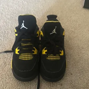 Jordan Black and Yellow Sneakers Air Jordan 4 Thunder