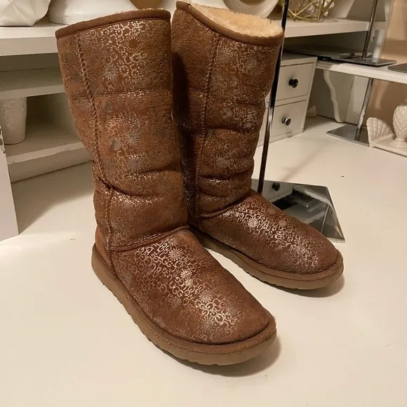 Uggs boots with light gold color logos all around the boots tan and gold