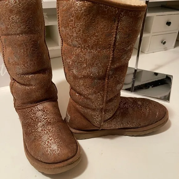 Uggs boots with light gold color logos all around the boots tan and gold